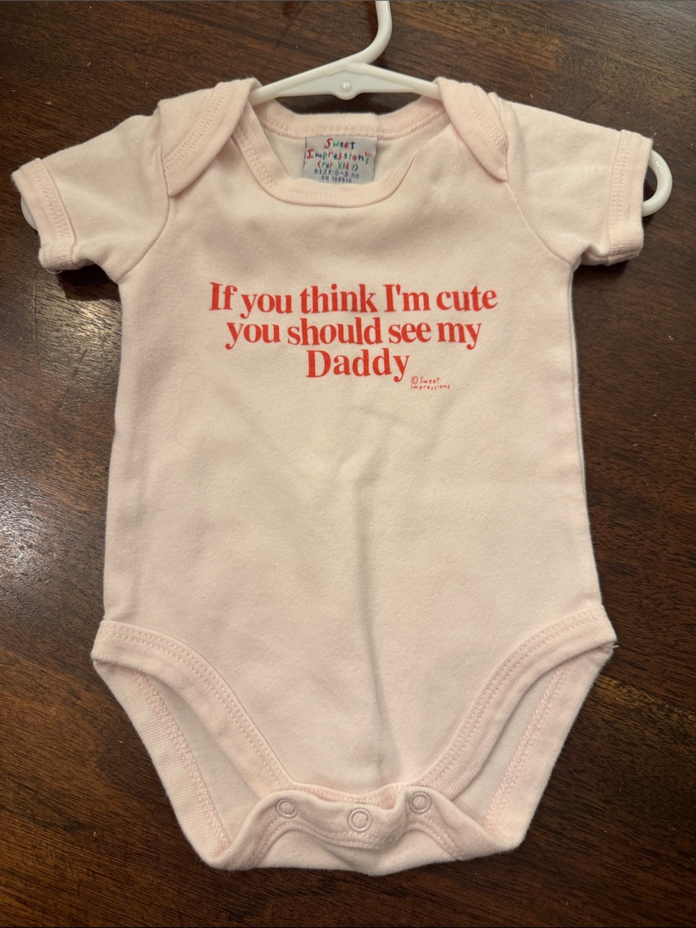 Impressions Pink Baby One-Piece with Red Text